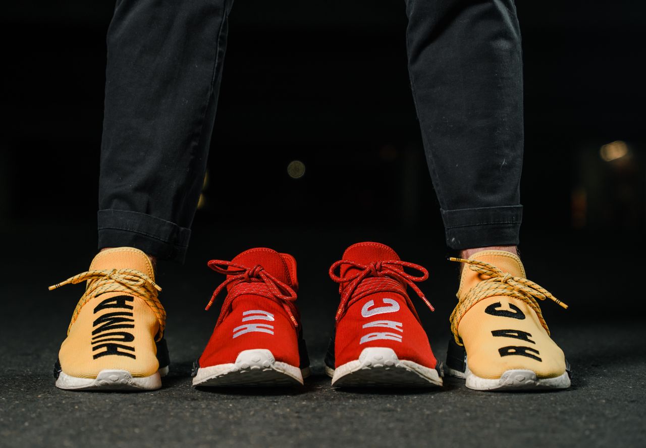 services-01 Vibrant red and yellow sneakers with bold text capture attention in a city night setting.