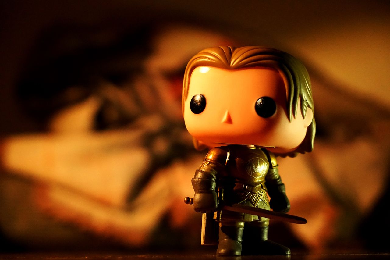 hero-img-02 A cute toy figure in armor with dramatic light and warm tones, perfect for creative projects.
